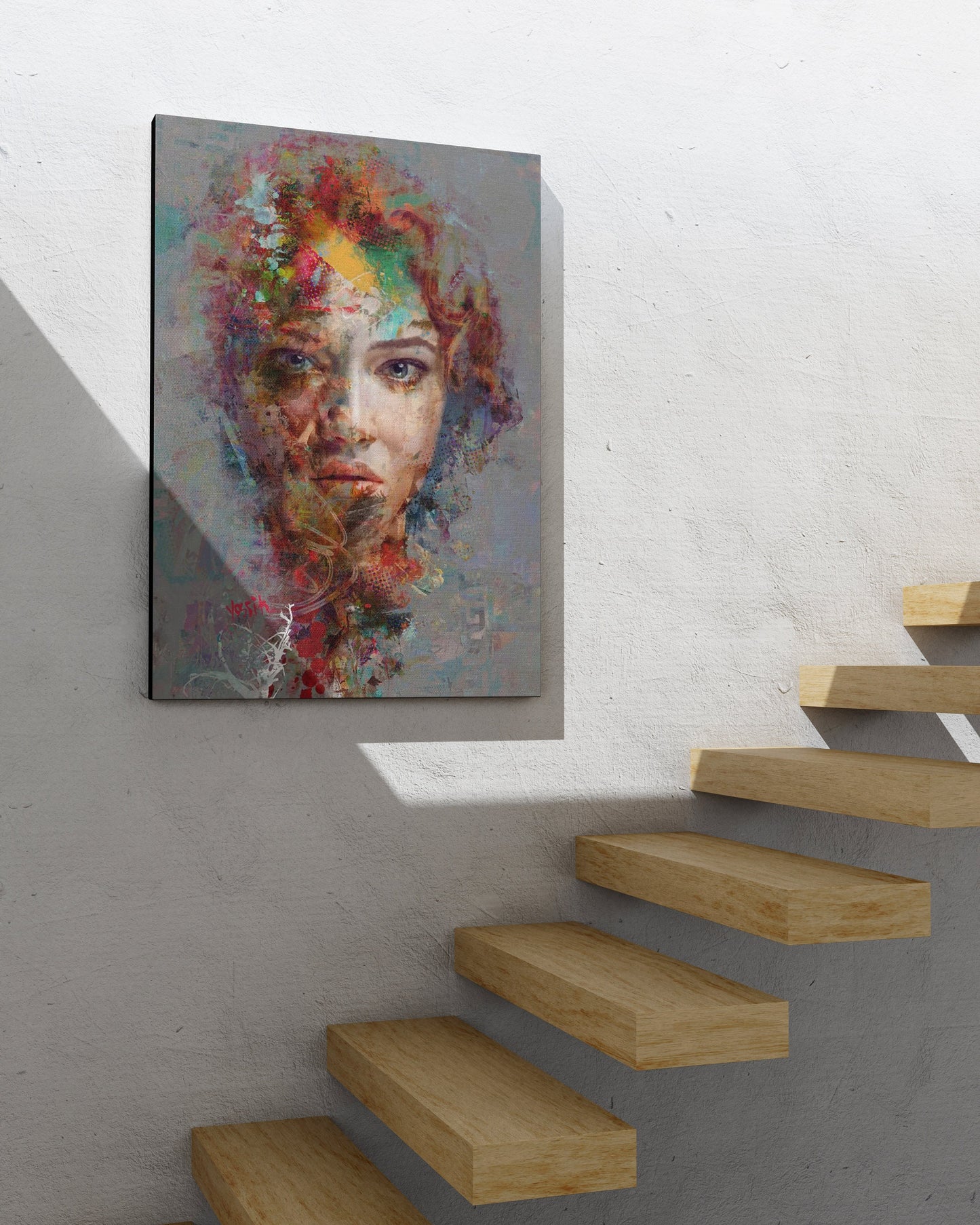 a painting of a woman's face on a white wall