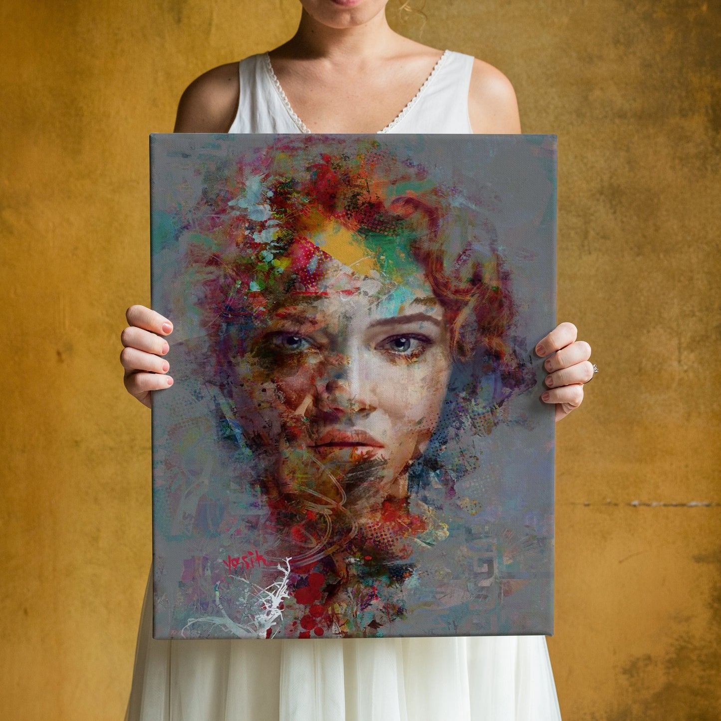 a woman holding up a painting of a woman's face