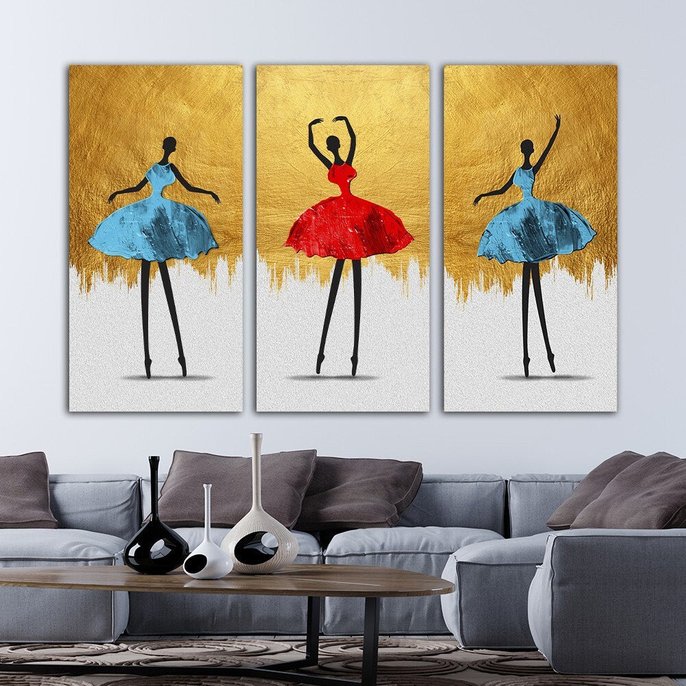 a living room with a couch and three paintings on the wall