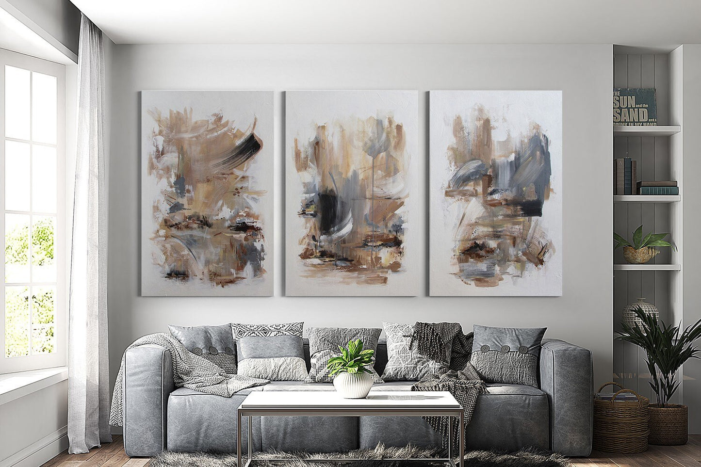 a living room filled with furniture and paintings on the wall