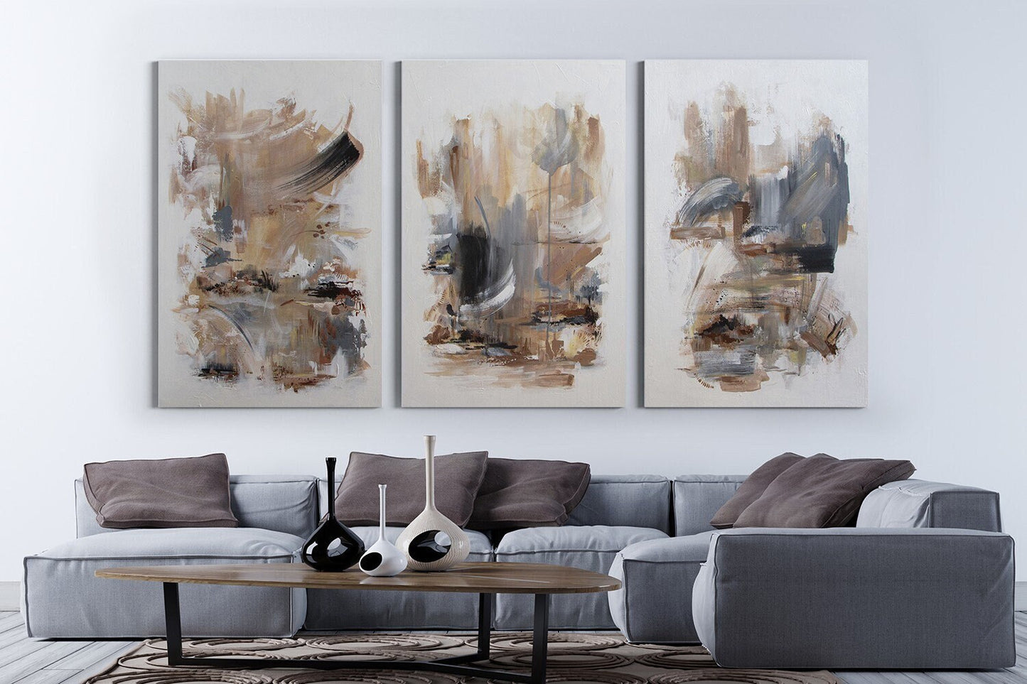 a living room with a couch and two paintings on the wall