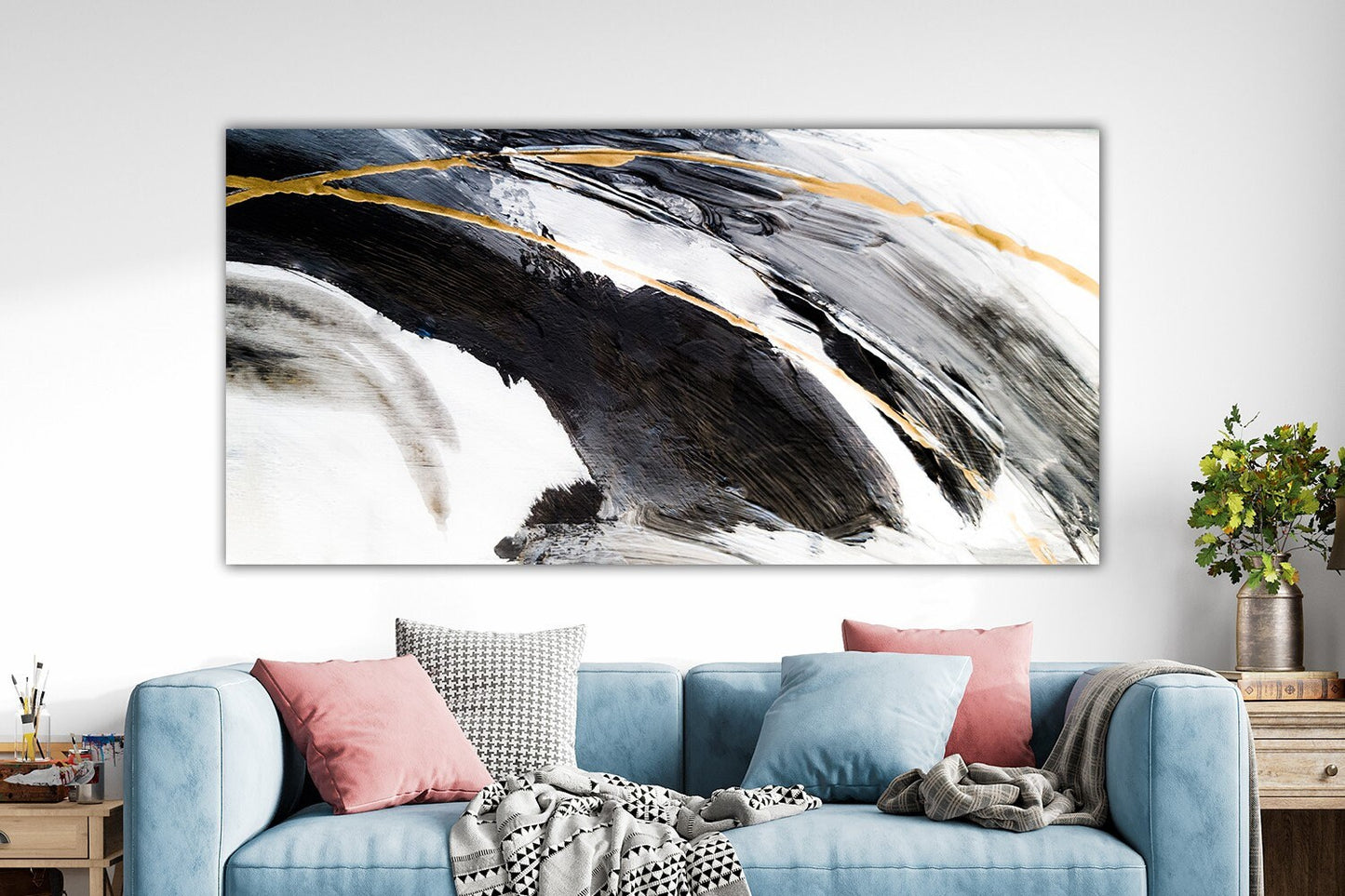 a living room with a blue couch and a painting on the wall