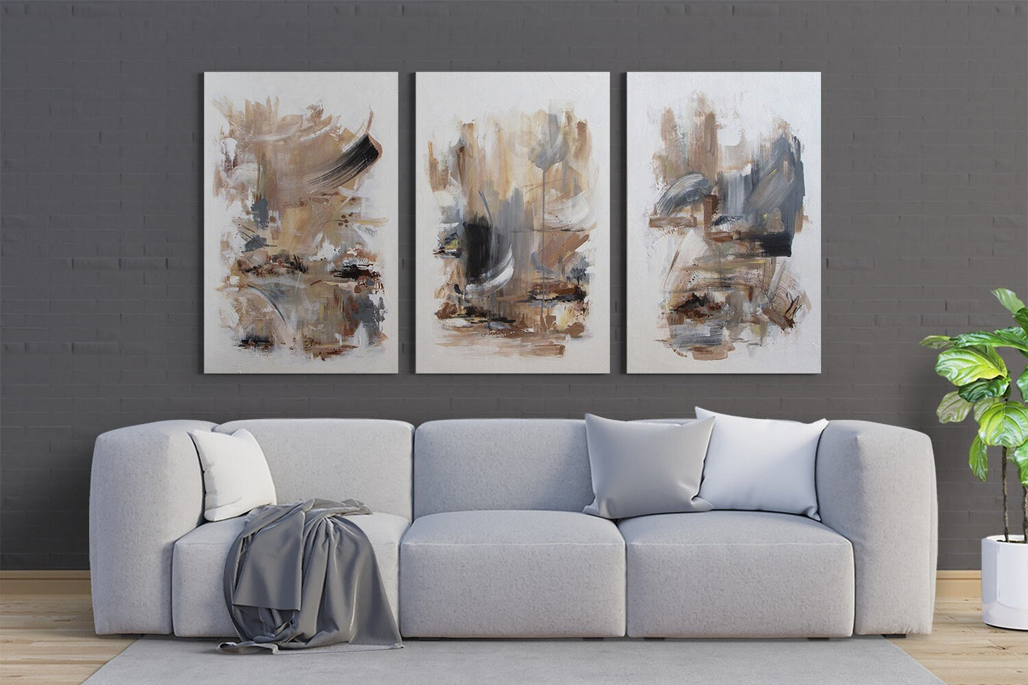 a living room with a couch and two paintings on the wall