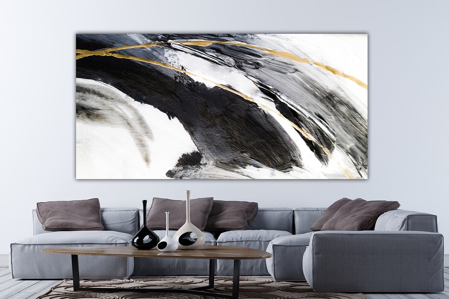 a living room with a couch and a painting on the wall
