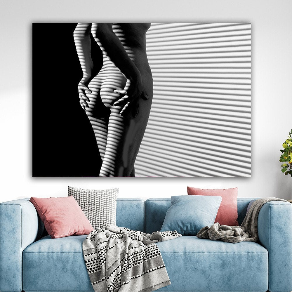 a living room with a couch and a painting on the wall
