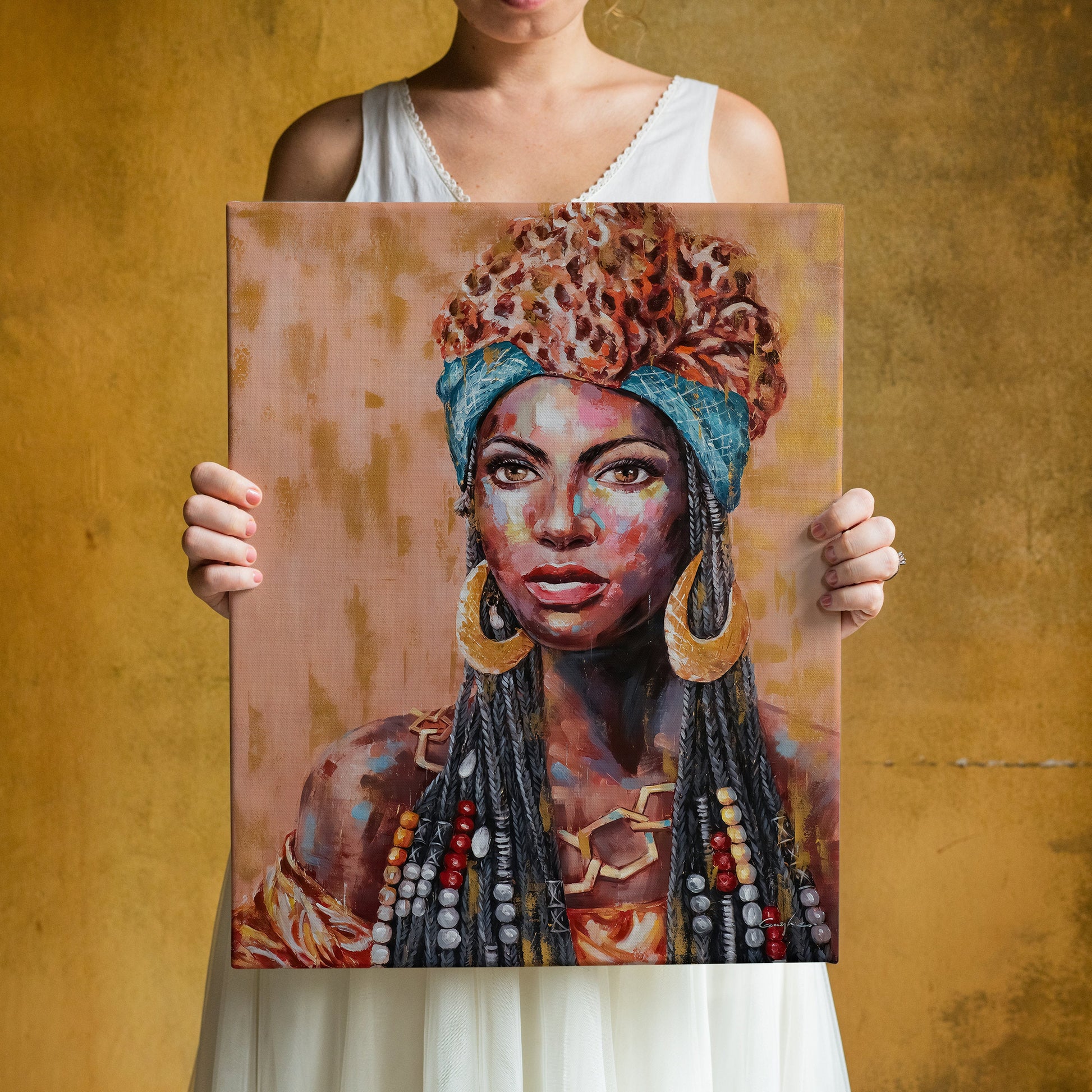 a woman holding up a painting of a woman wearing a headdress