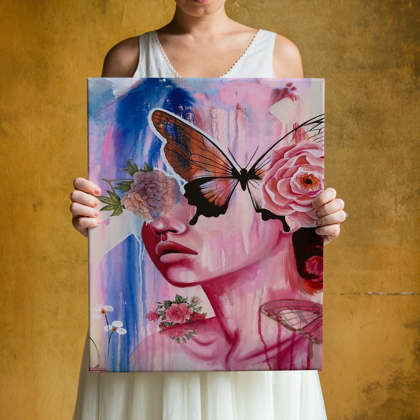 a woman holding up a painting with a butterfly on it