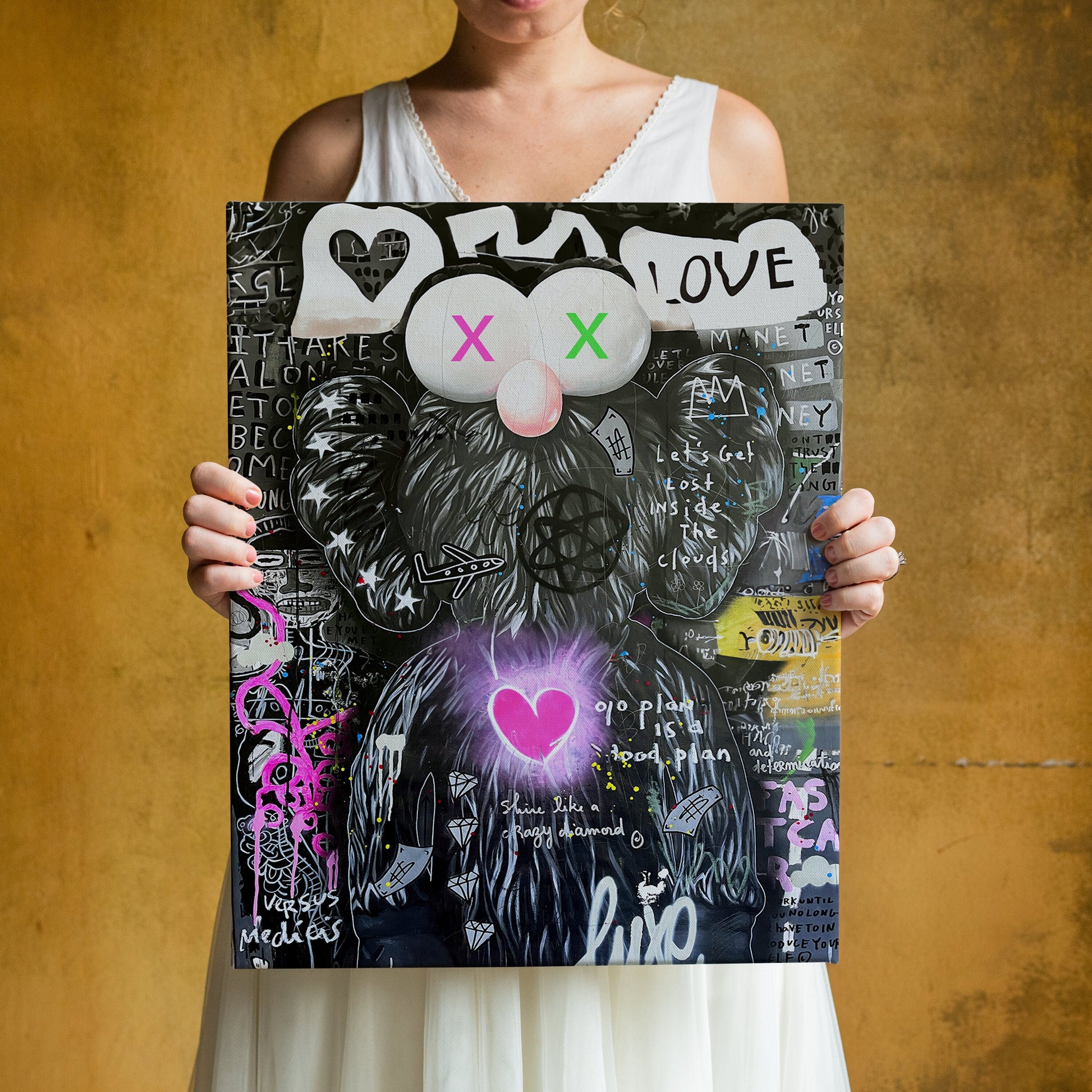 a woman holding up a poster with a cat on it