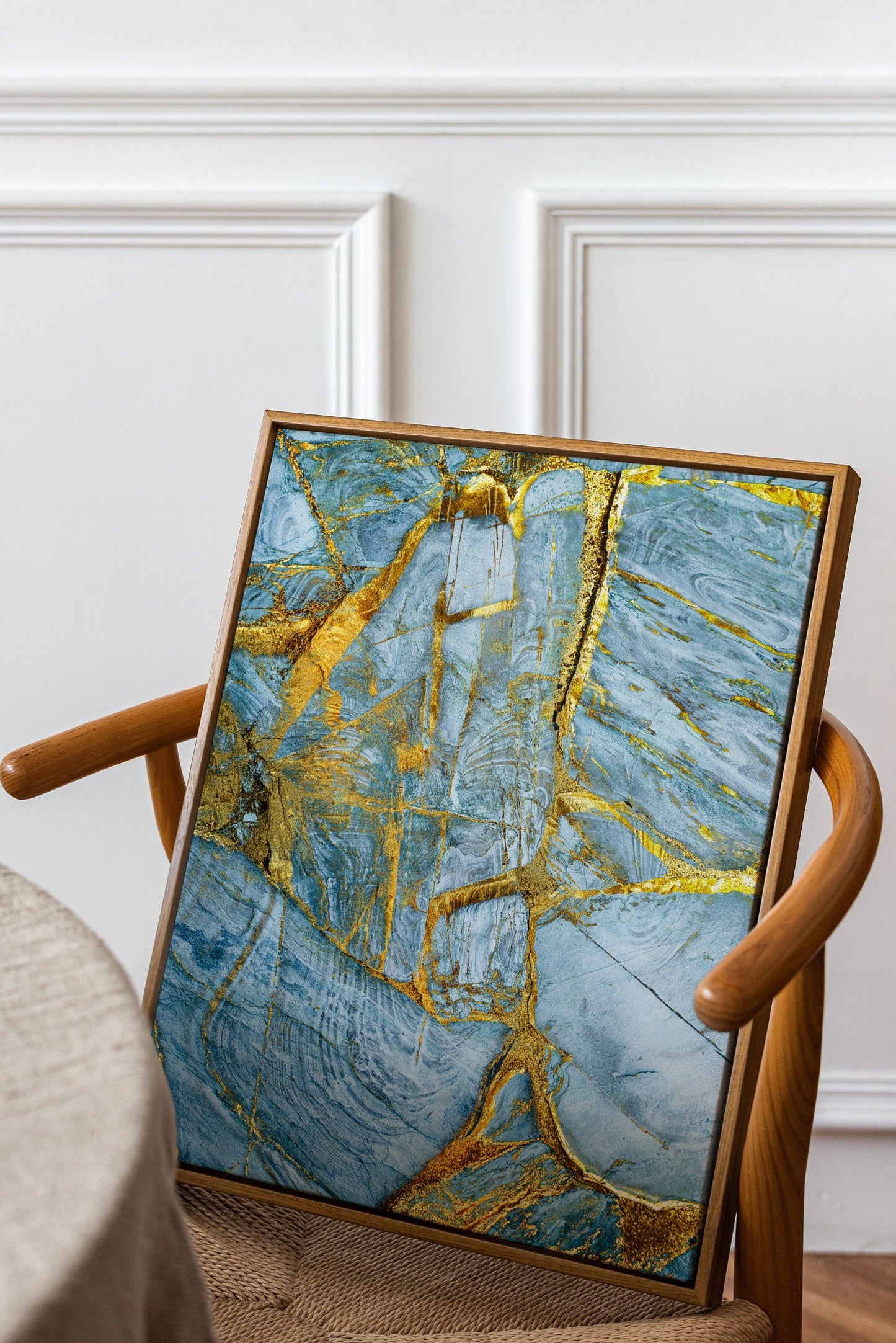 a chair with a painting on it in a room