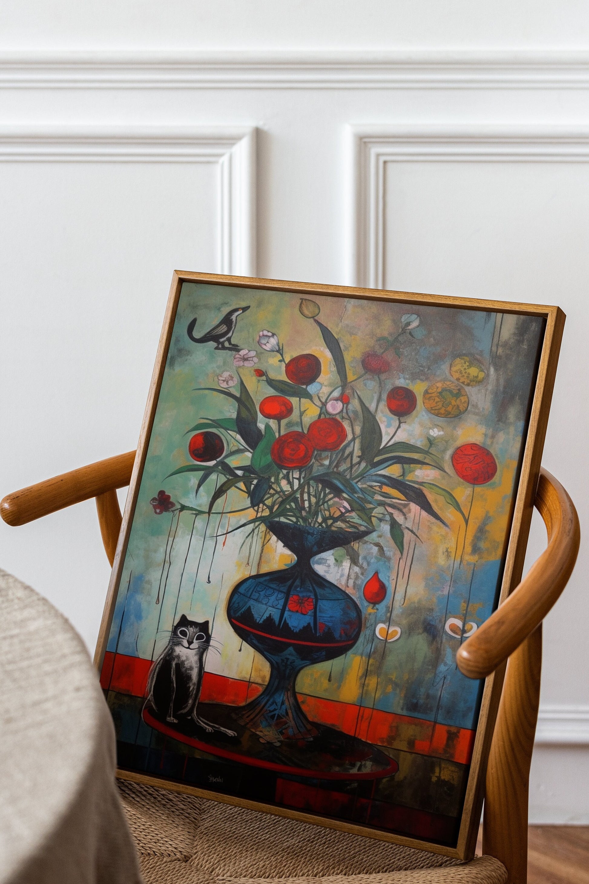 a painting sitting on top of a wooden chair