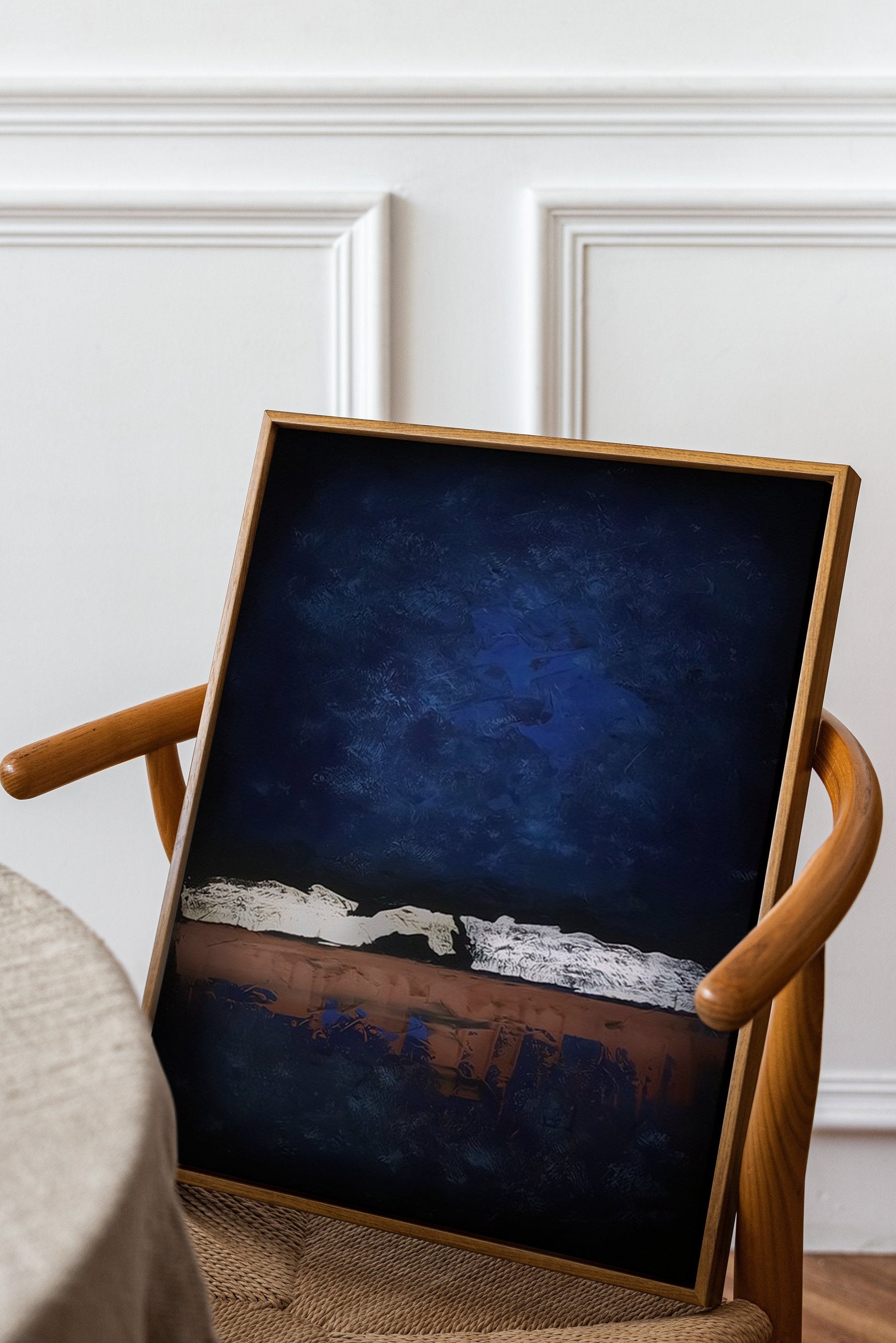 a chair with a painting on the back of it