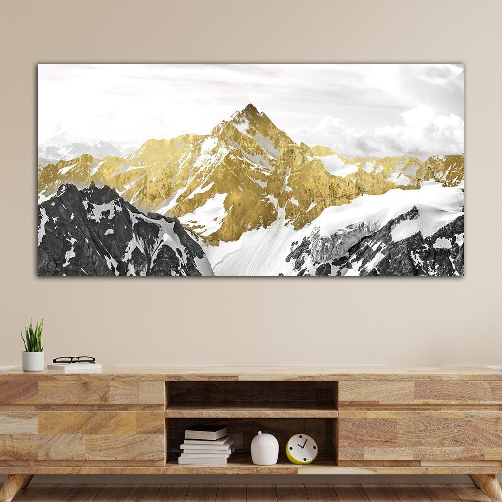 a painting of a snowy mountain range in gold and white