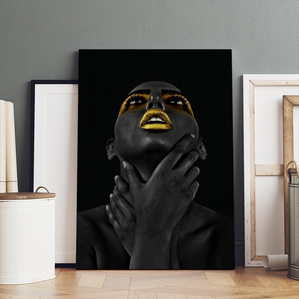 a black woman with gold painted on her face