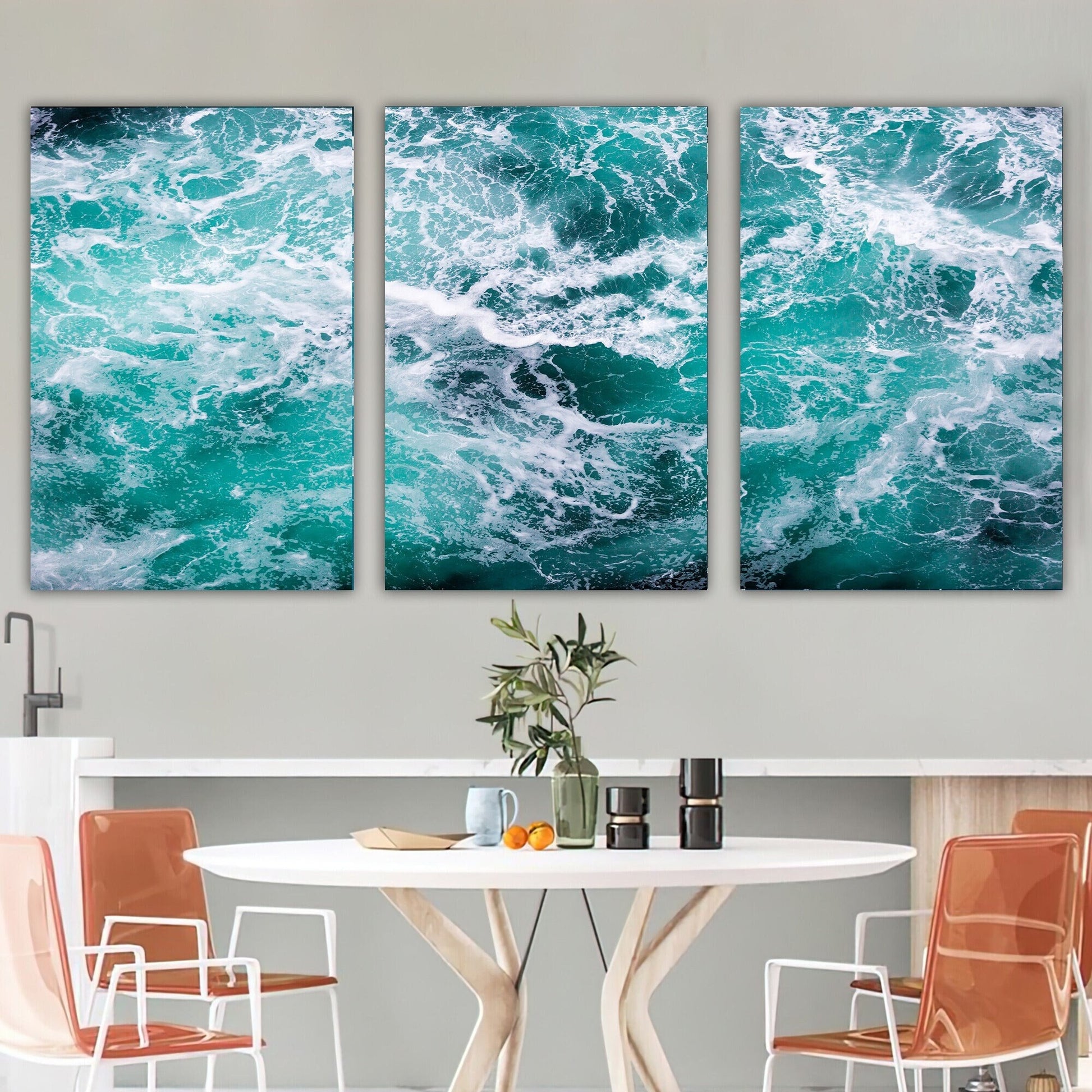 a dining room table with chairs and two paintings on the wall