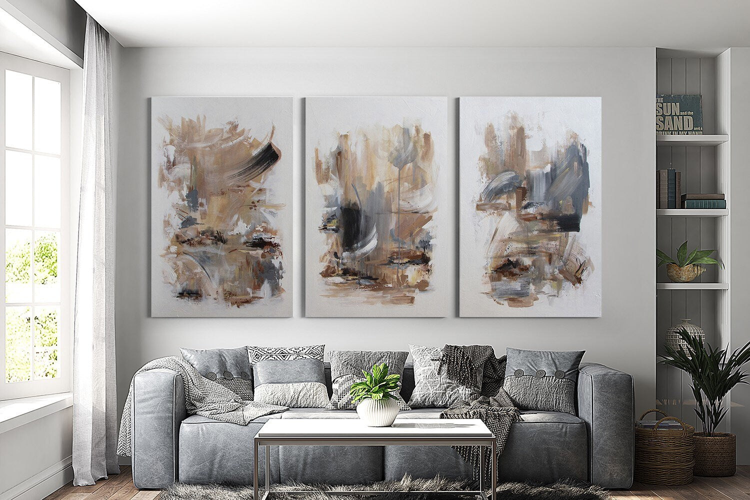 a living room filled with furniture and paintings on the wall