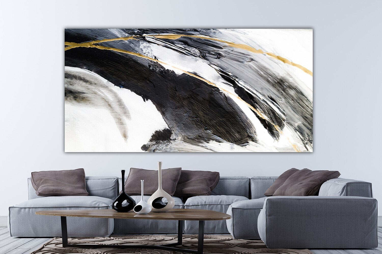 a living room with a couch and a painting on the wall